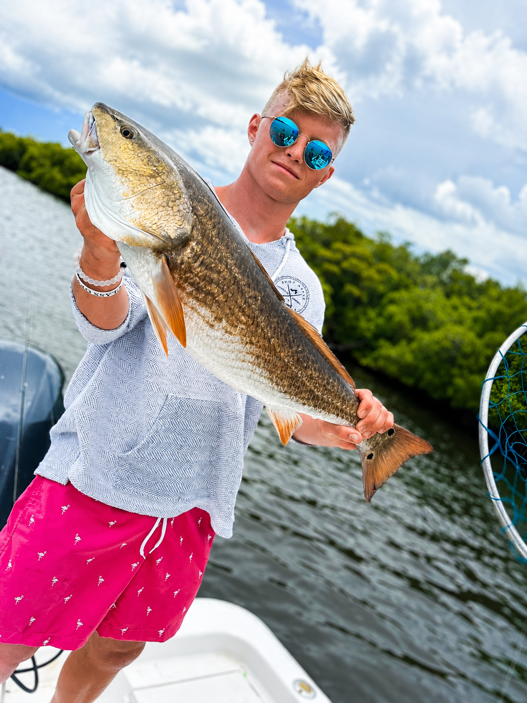 A young angler with a redfish